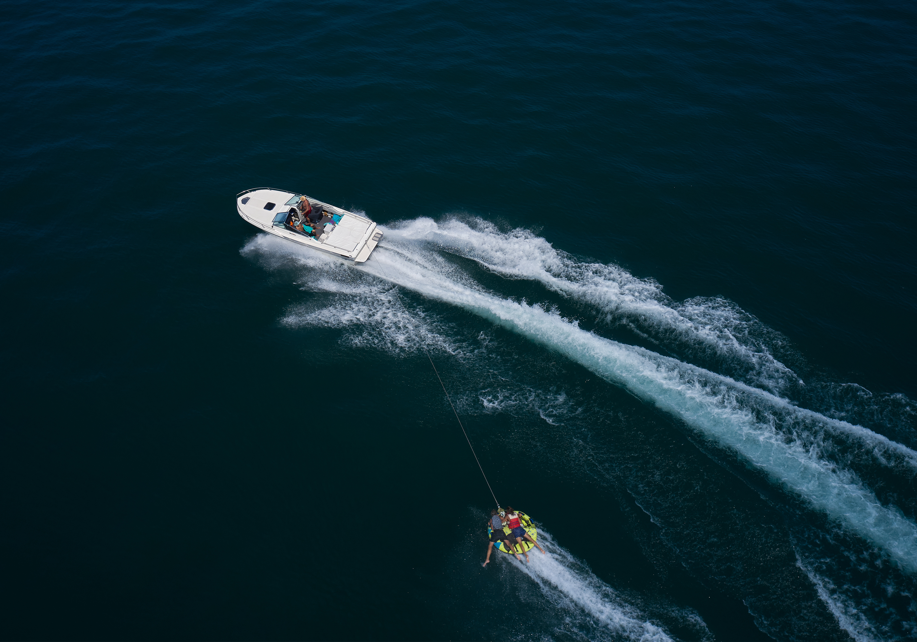 Boat on the water pulling a tube