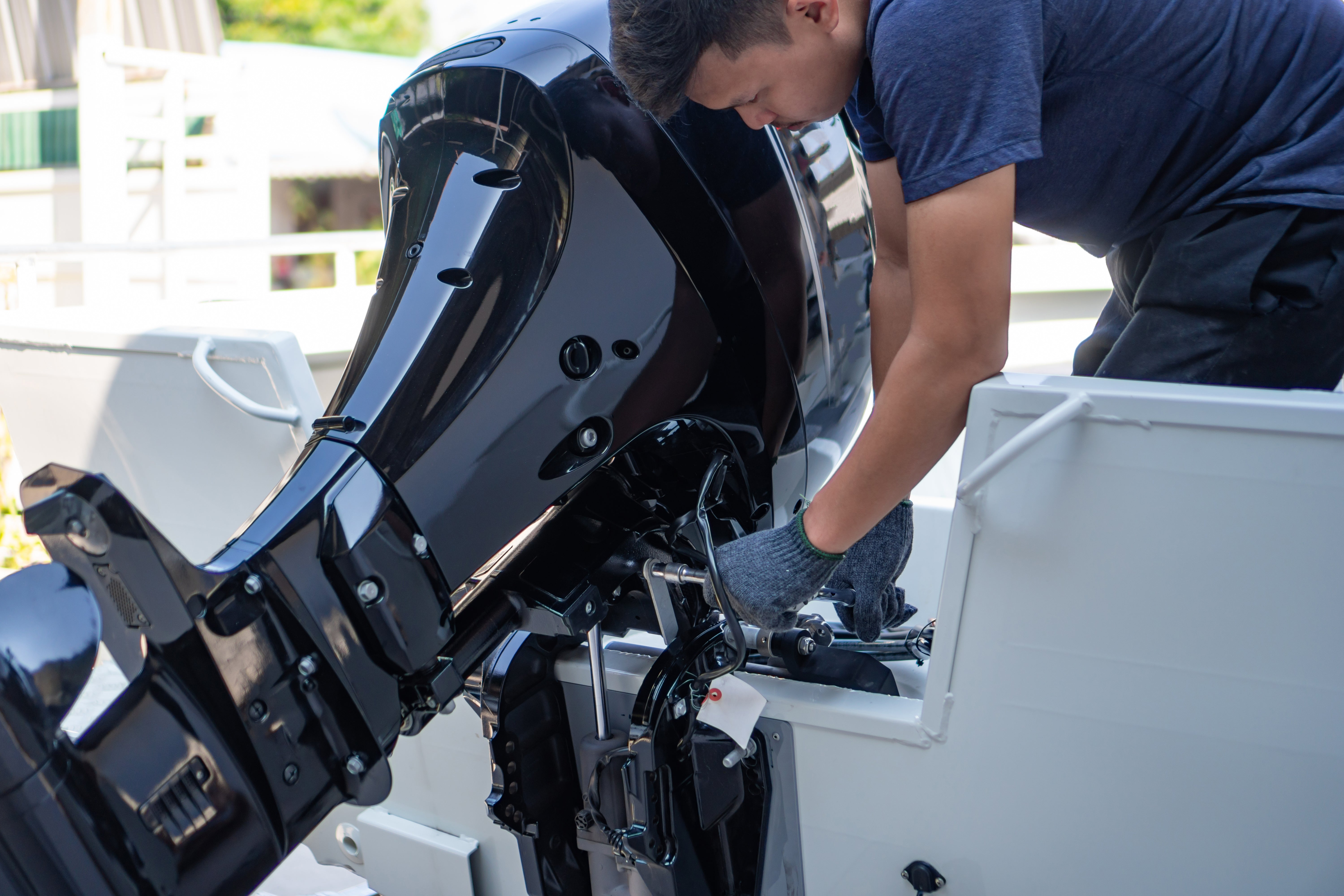 A man repairing a boat engine