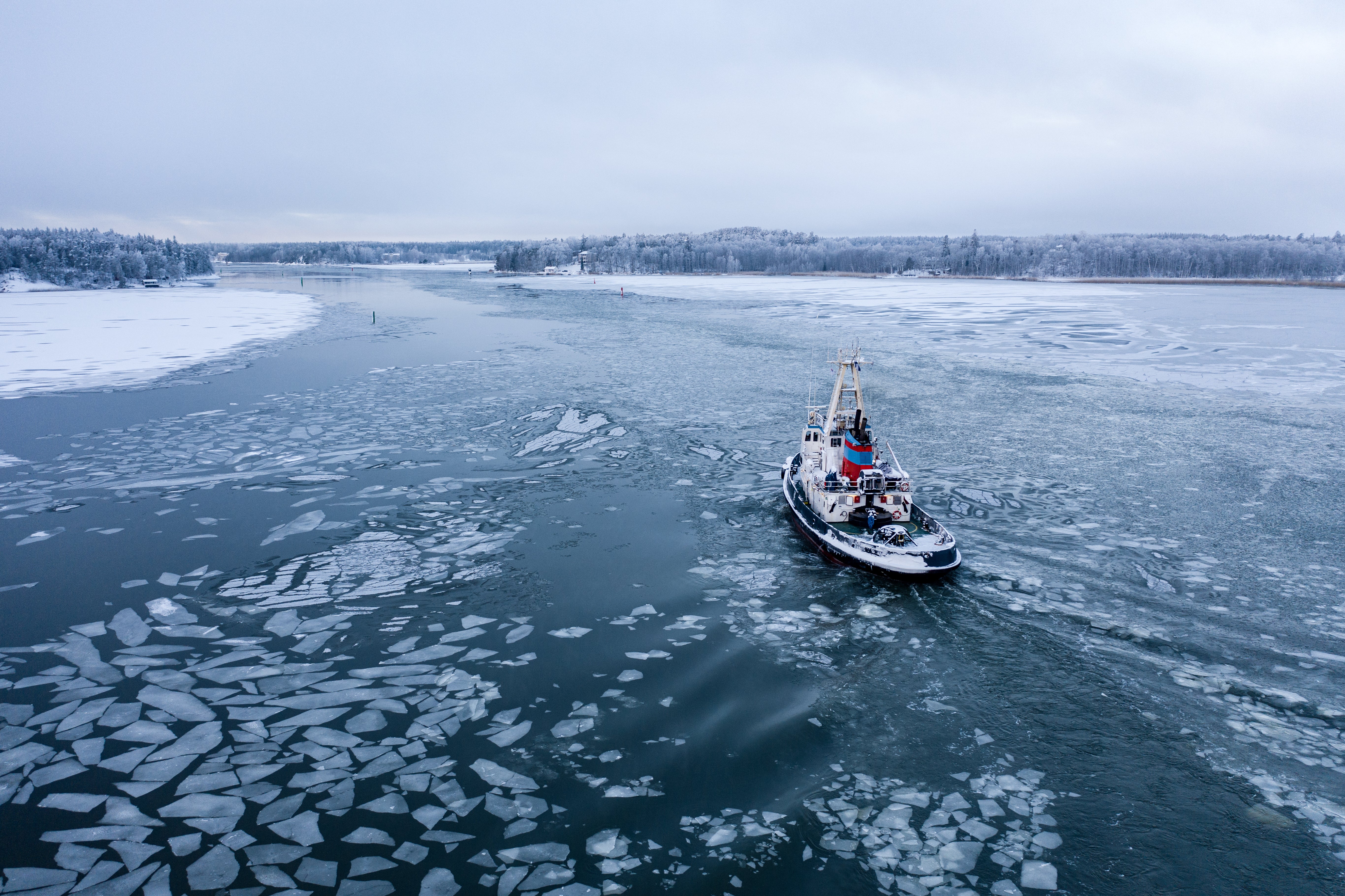 Icebreaker boat moving through winter water