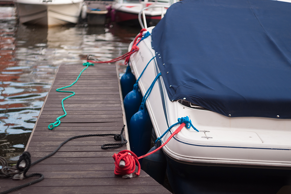 Covered boat tied up at a dock